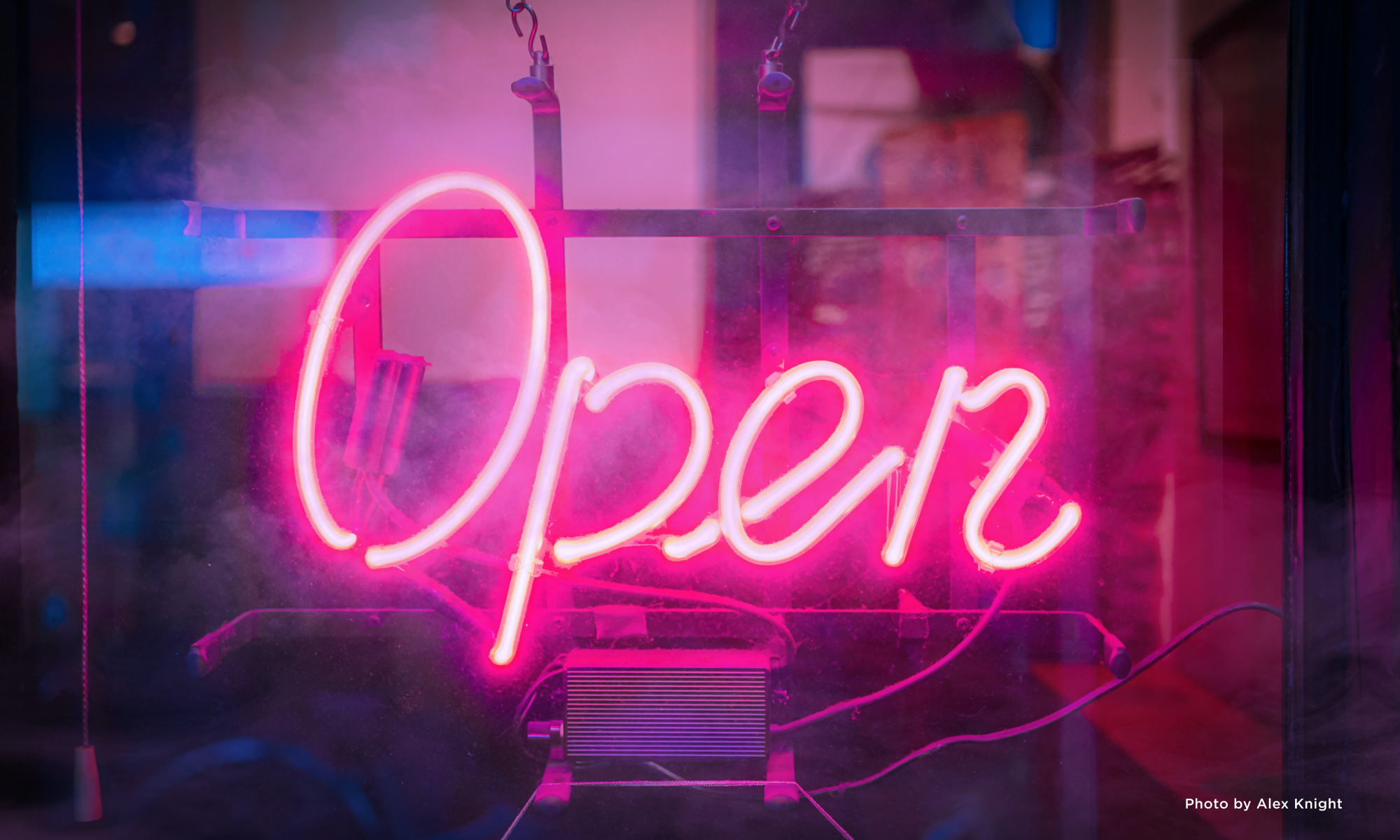 A lit-up neon sign that reads, "Open."